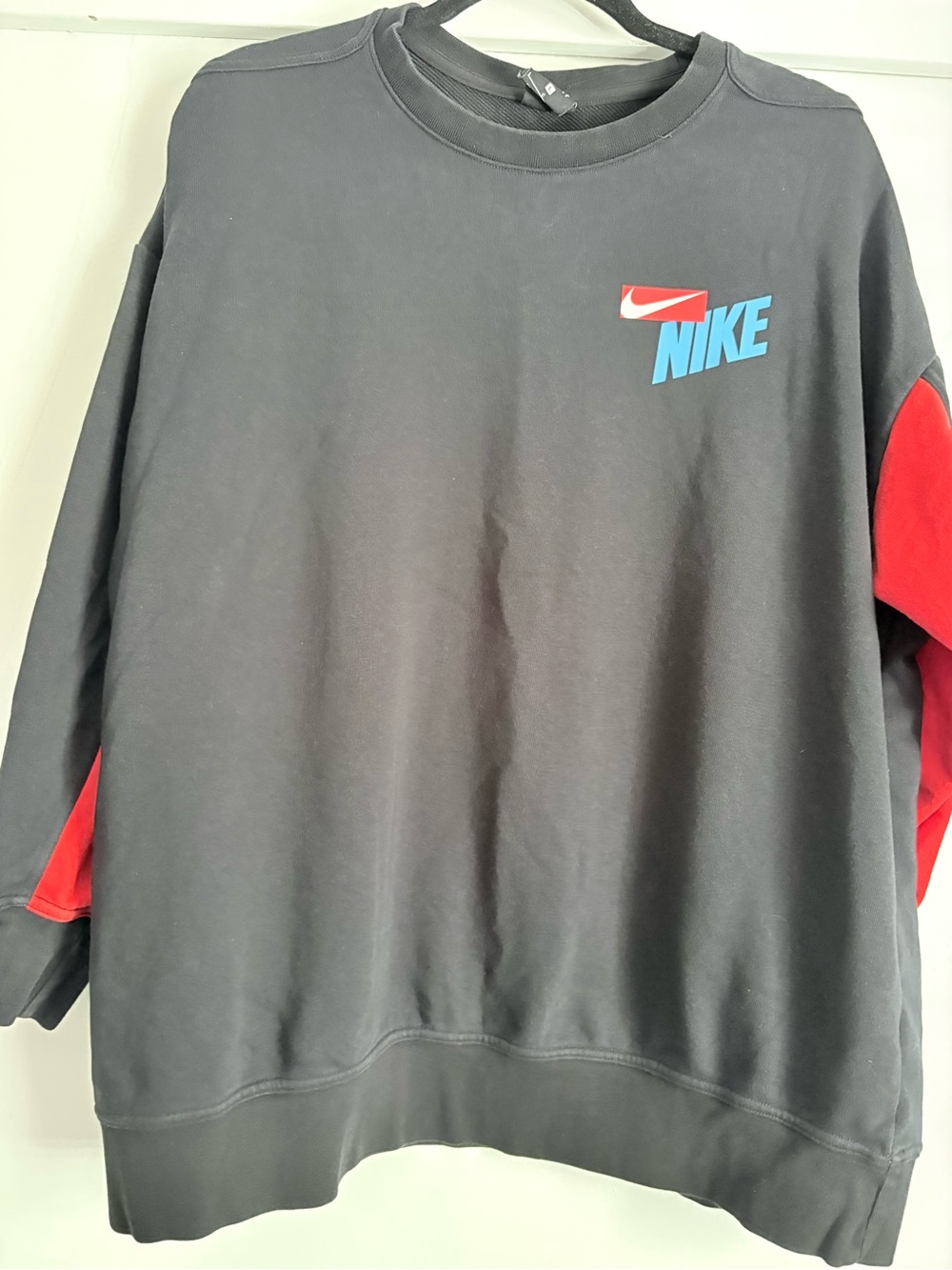 Nike Black Crewneck Sweatshirt with Red Sleeve Panels and Blue Logo